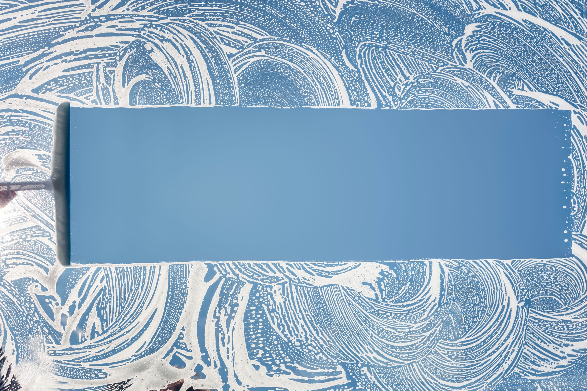 Window cleaner using a squeegee to wash and clean a window